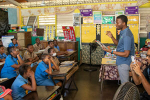 man reading to school children