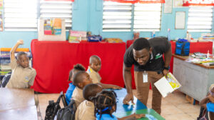 man listening to children in a classroom