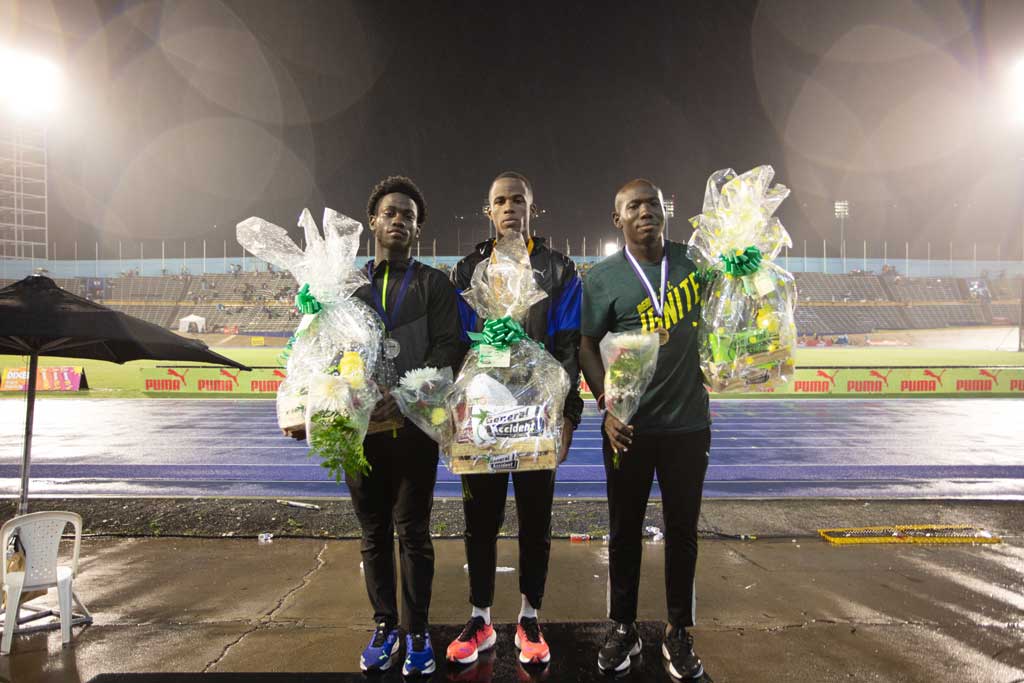 nigel-ellis-1 Nigel Ellis of Elite Performance Track Club (centre) who won the Men's 100m final at the Gibson-McCook Relays held at the National Stadium in Kingston, on Saturday February 24th is flanked by Javorne Dunkley (left) also of Elite Performance Track Club and Jazeel Murphy of Dynamic Athletics Track Club after received their gift packages which were donated by race sponsor General Accident.