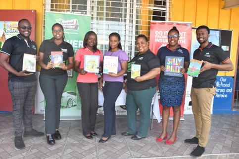 read-across-jamaica-3 The General Accident team gathers with their selected books before their annual reading session for Read Across Jamaica Day on Tuesday, May 7, 2024. (From left) Dadrian Williams, Lotoya Smith, Sheneka Mitchell, Shandale Preddie, Choye Chan-Scott, Aaliyah Campbell, and Sha Vaughn Rattigan were ready to inspire the children of Dunrobin Primary School.